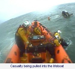 Casualty being pulled into the lifeboat